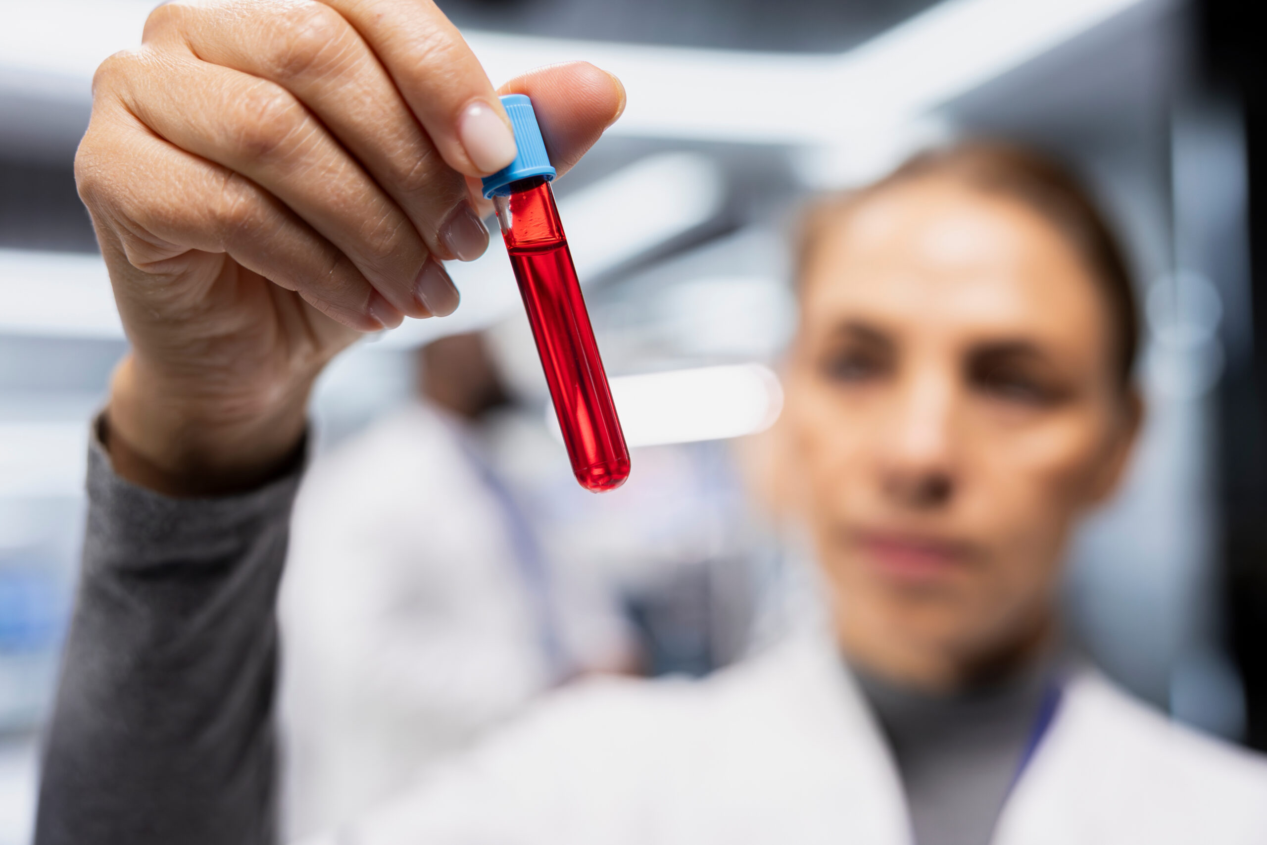 woman-scientist-collecting-checking-blood-test-tubes